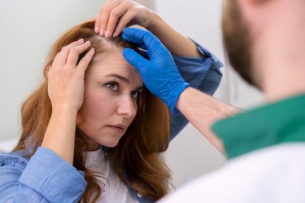 woman getting hair loss treatment clinic of south county