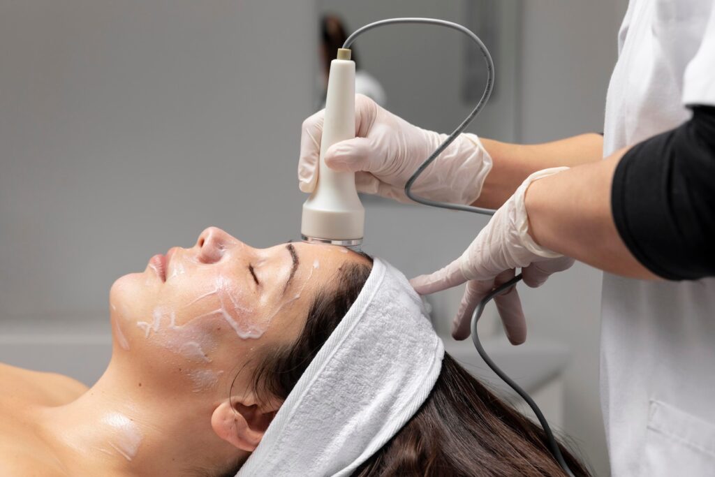Young woman getting a microdermabrasion facial treatment at a clinic.